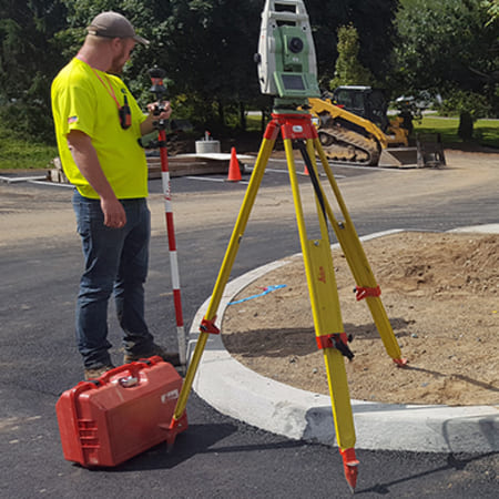 Surveyor on street corner